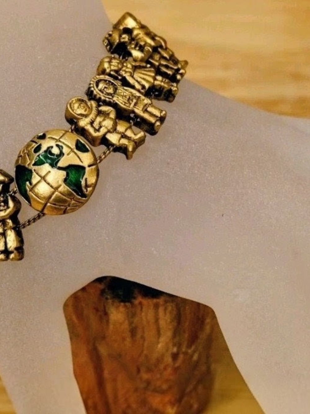Gold-Tone World Charm Bracelet with Green Enamel Accents